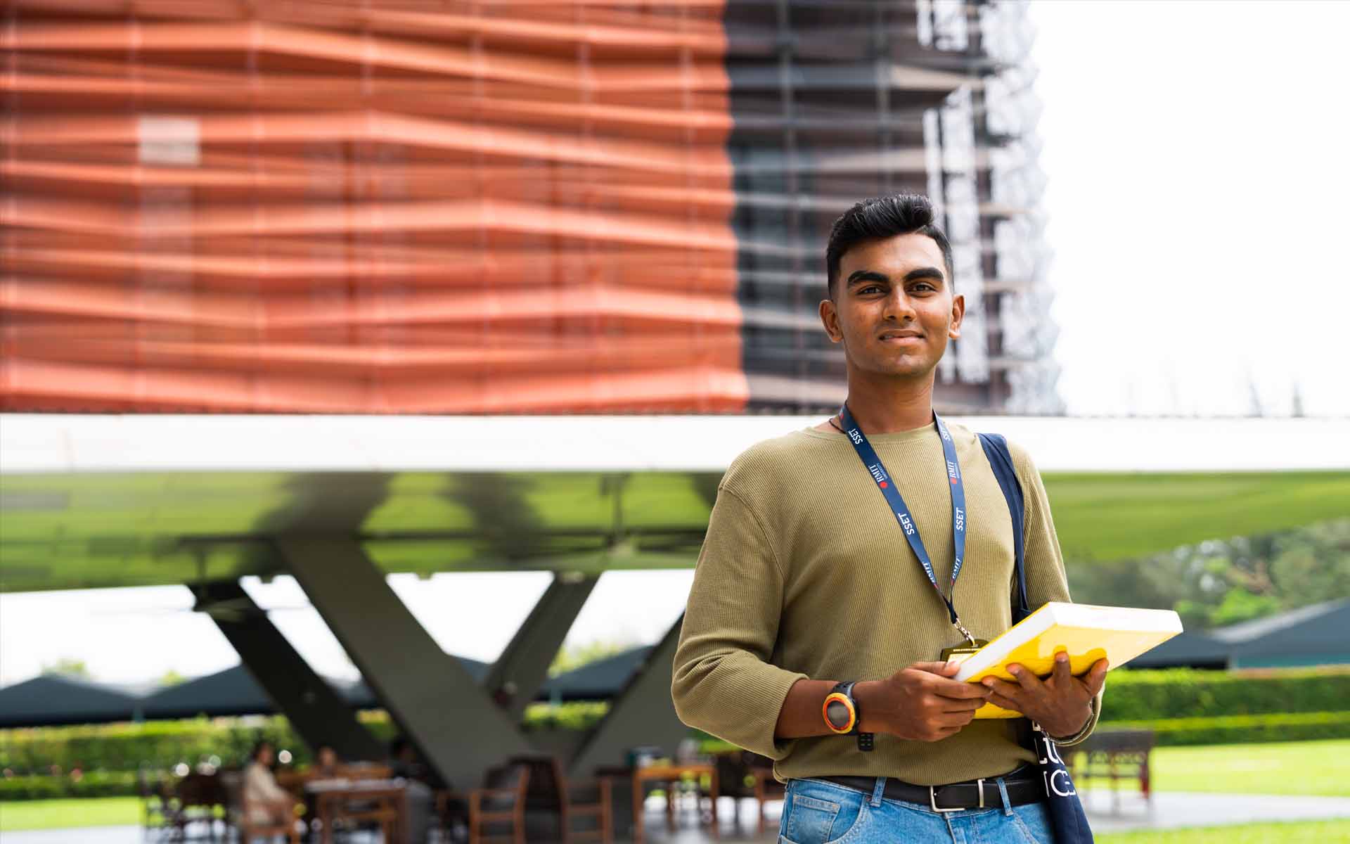 a male student sitting in the school campus 
