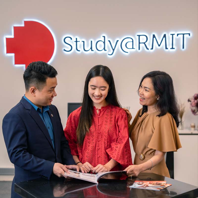 a female student and her parents talking in university campus