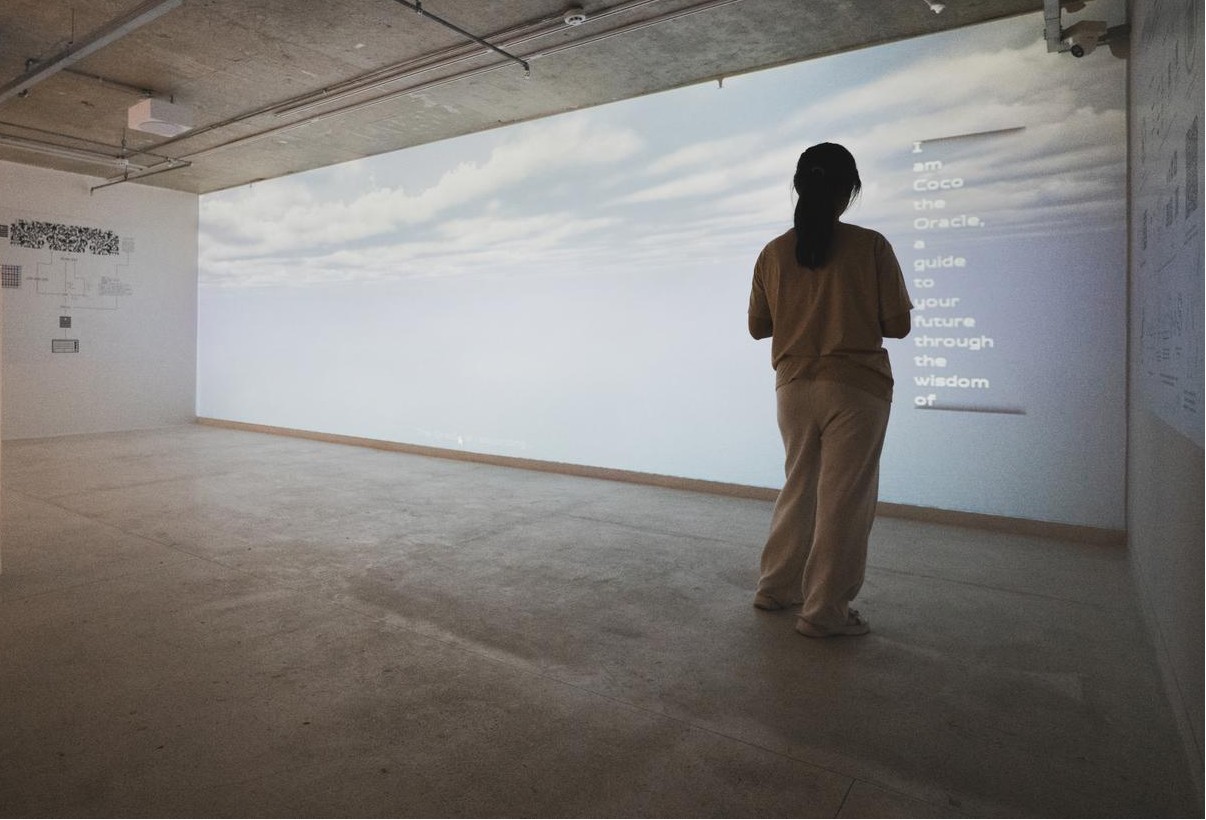A girl standing in front of a screen