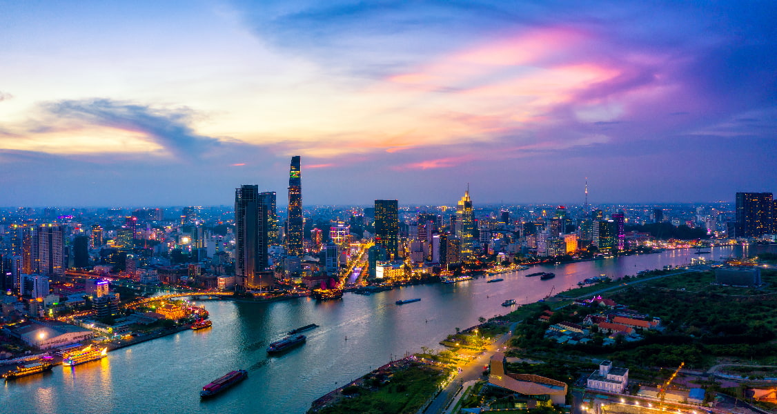 Panorama of Ho Chi Minh City and the Saigon river at sunset.