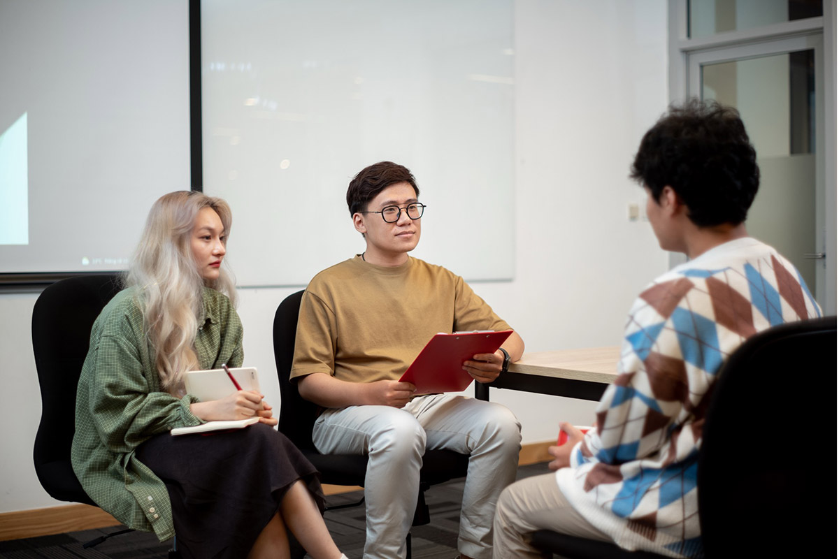 Ba bạn sinh viên đang thực hành tham vấn tâm lý trong lớp