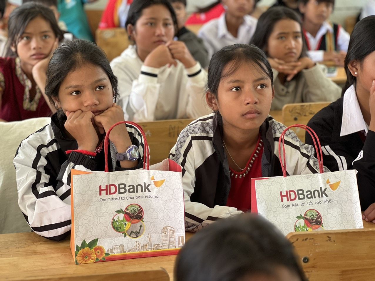 Students with HDBank gift bags in classroom