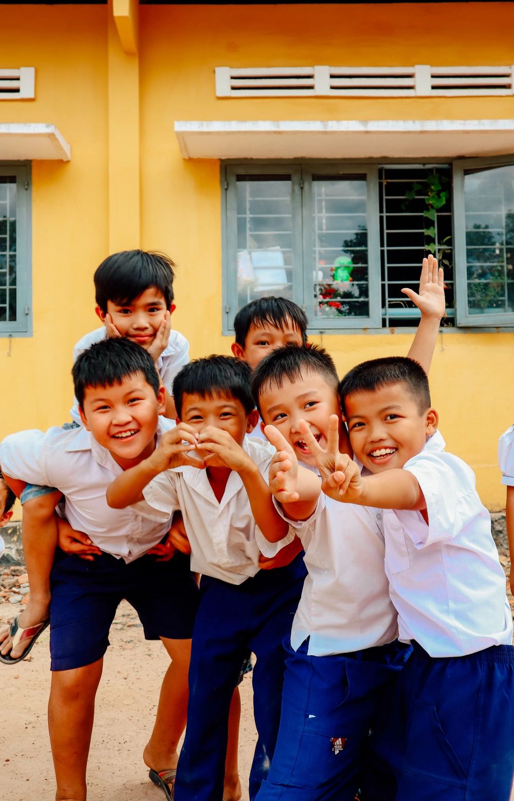 Primary school students smiling and playing together outdoors