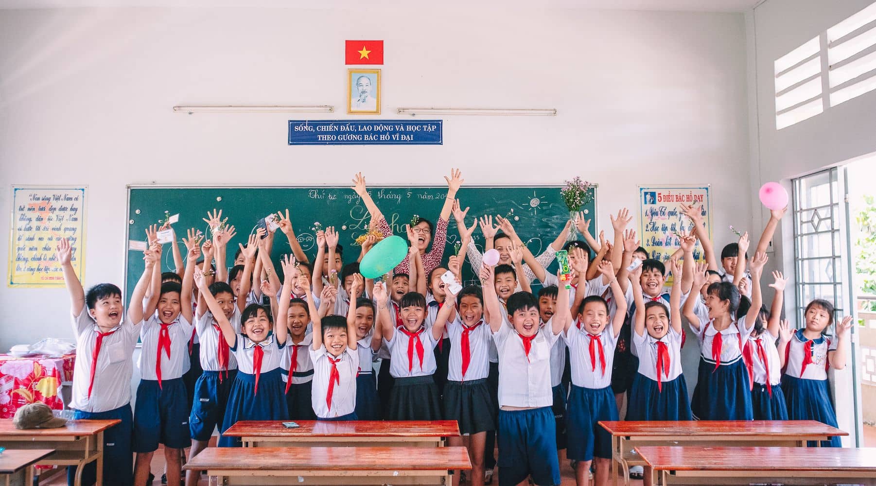 Teach For Vietnam fellows celebrating with students in classroom