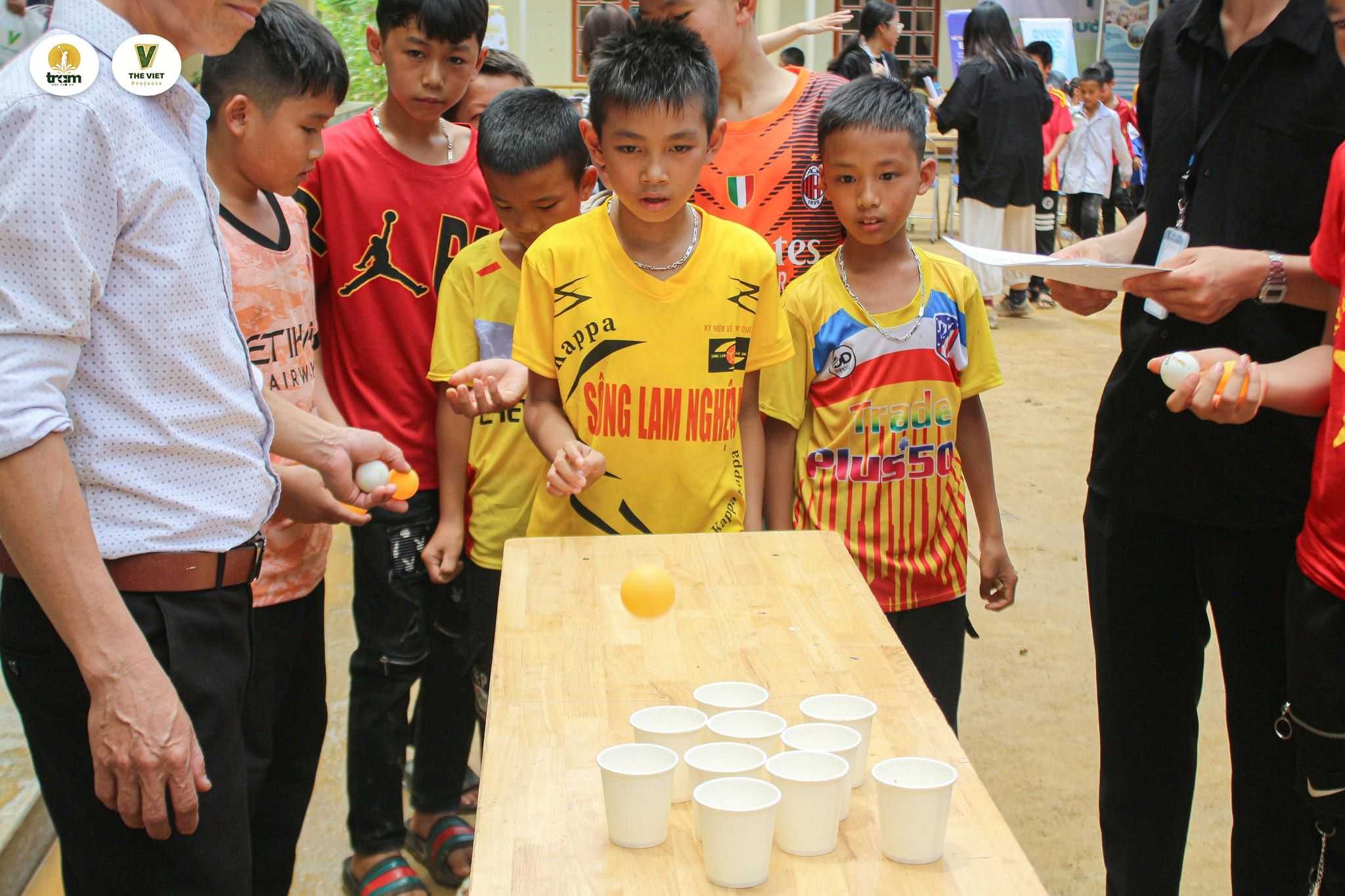 Kids playing a cup-and-ball activity