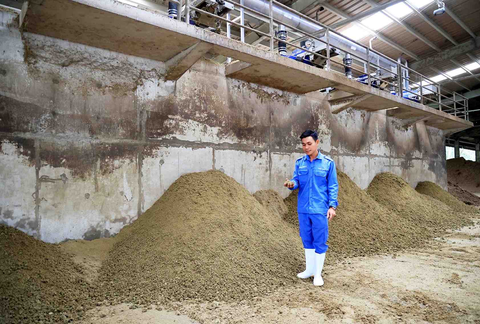 Technician inspects organic fertiliser at Vinamilk’s biogas facility