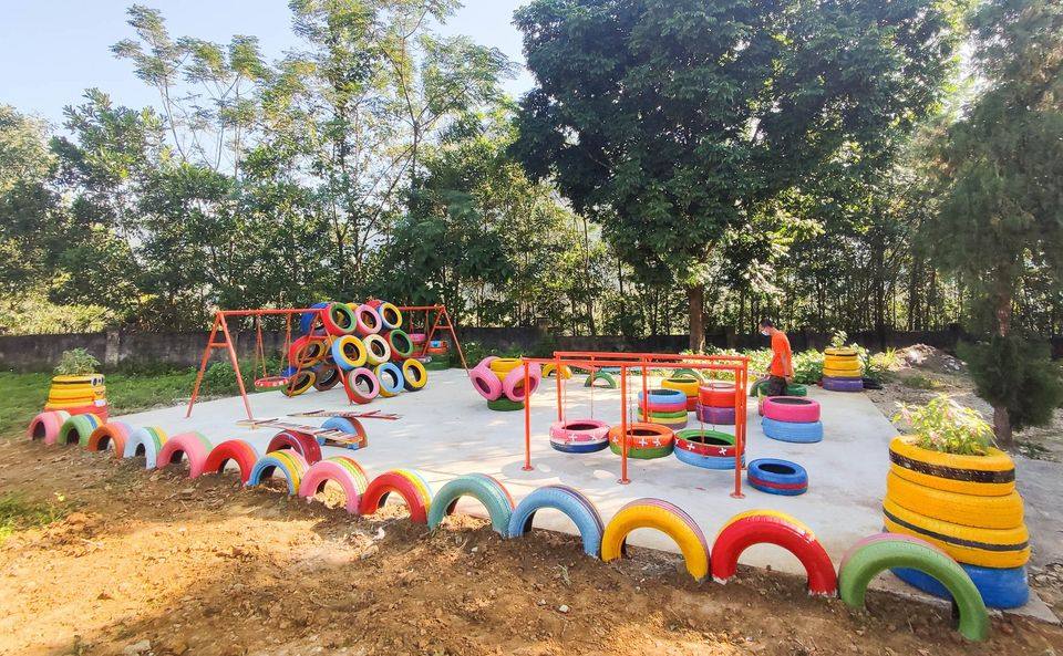 Wheel of dreams playground built from colourful recycled tyres