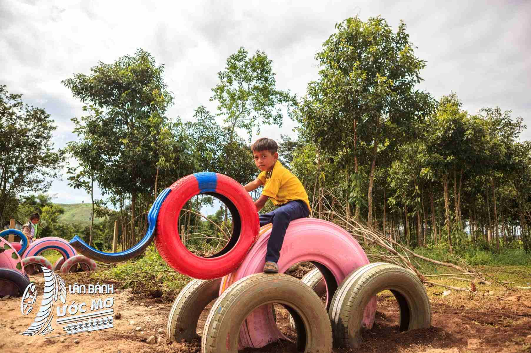 Child rides elephant-shaped tyre sculpture at Wheel of dreams playground