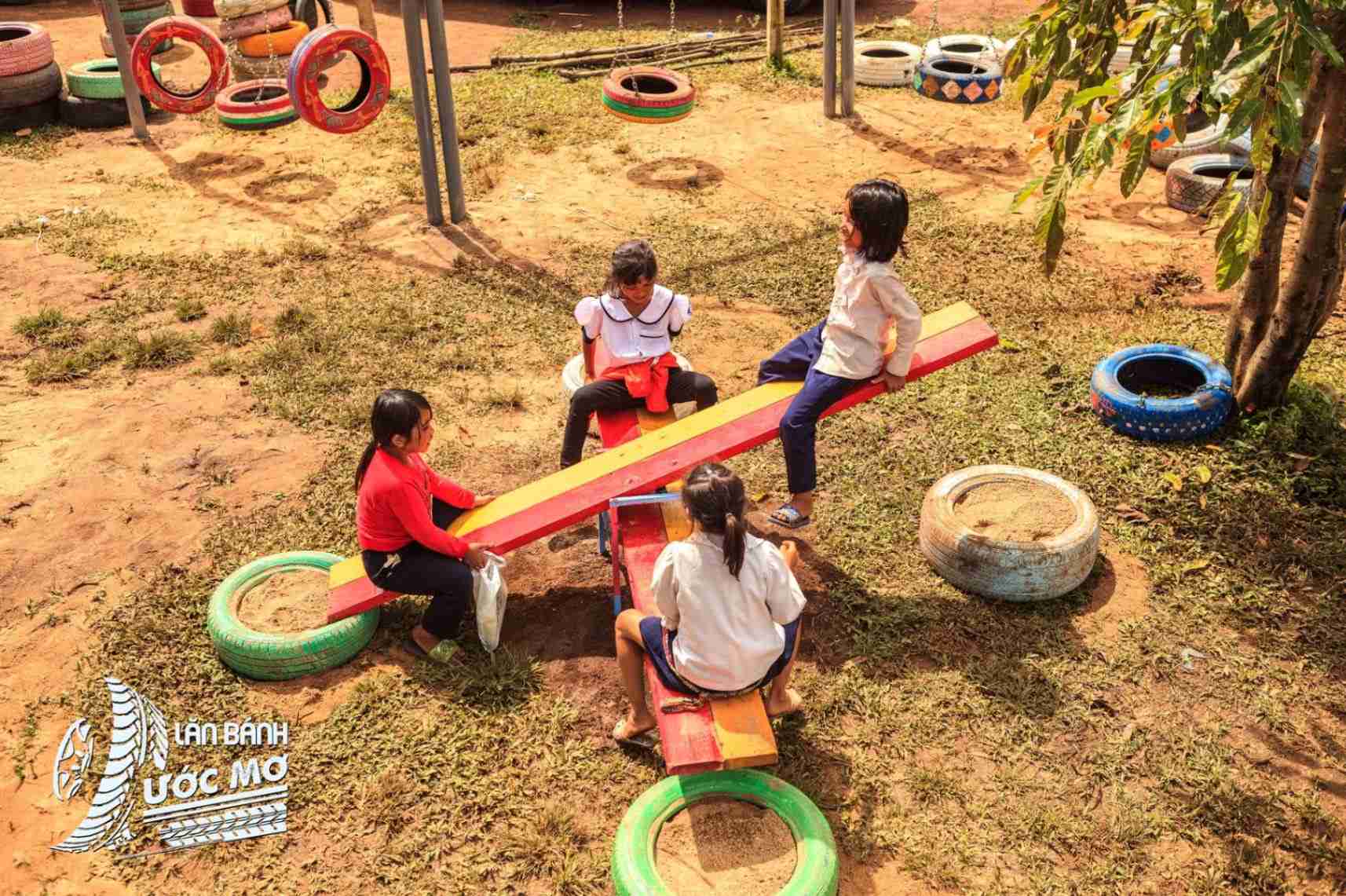 Children playing in a Wheel of dreams playground
