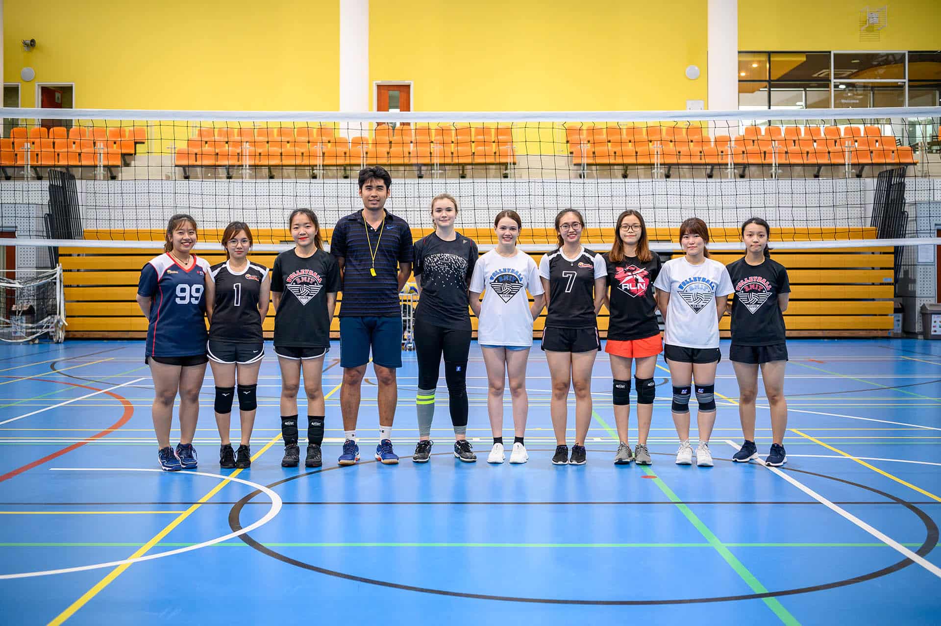SGS Volleyball club standing on the volleyball court.