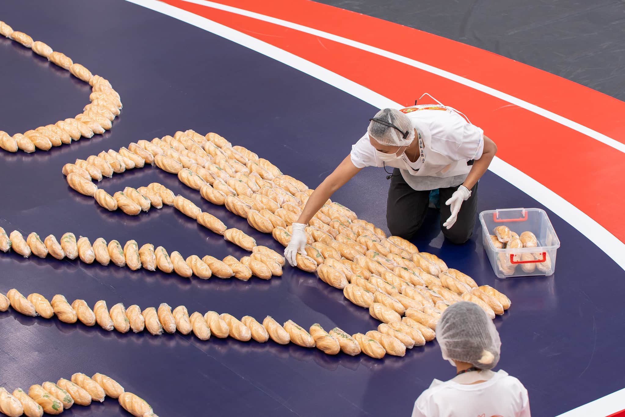 The number 25 made from banh mi is taking its shape.