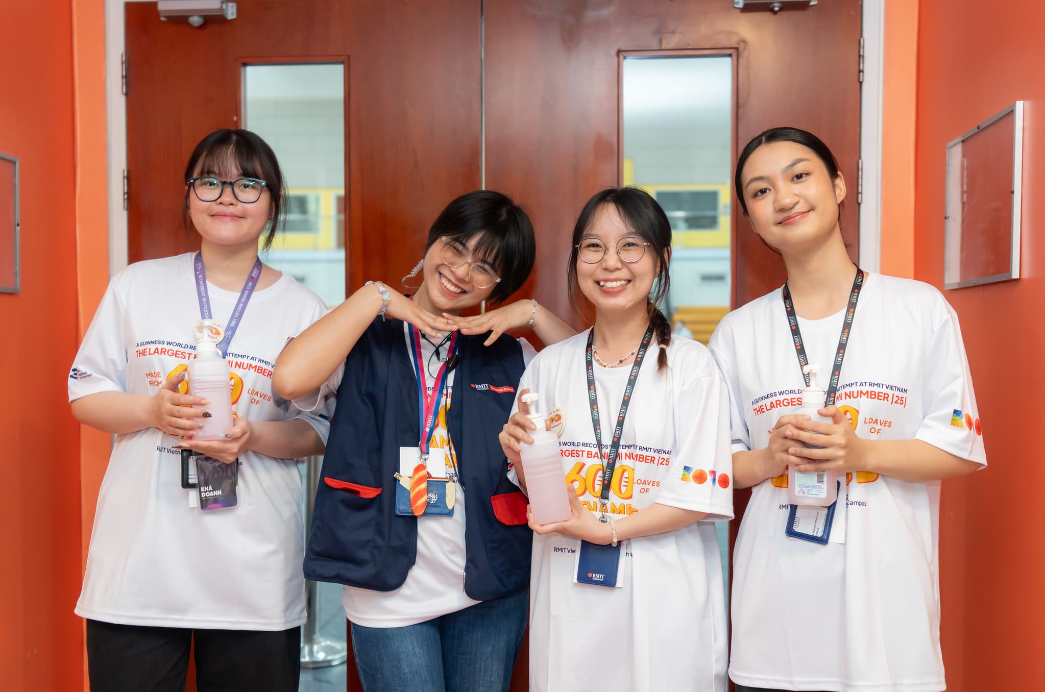 Student volunteers sanitazing their hands before heading into the making station.