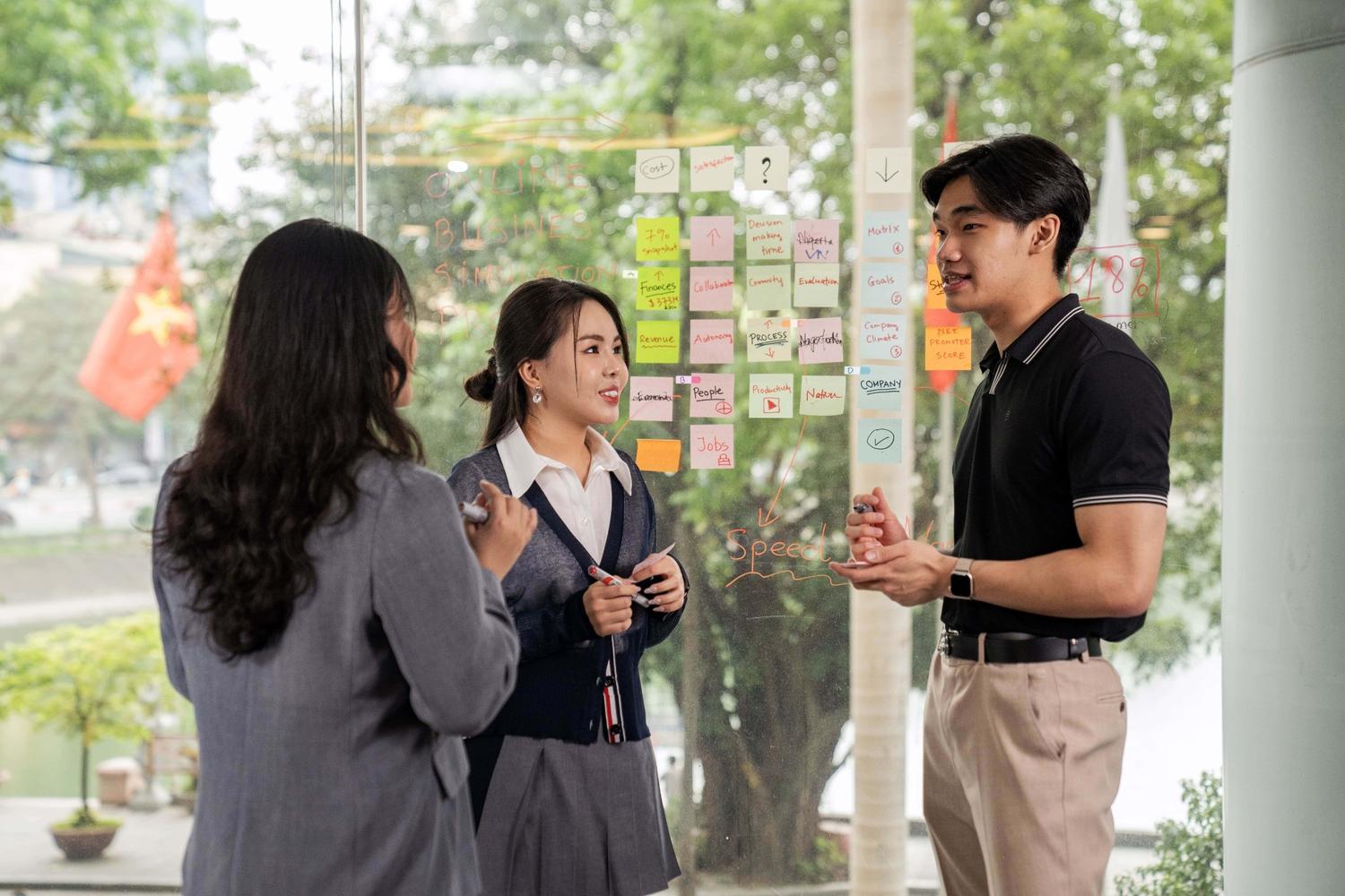 newbie-101-three-students-standing-and-discussing