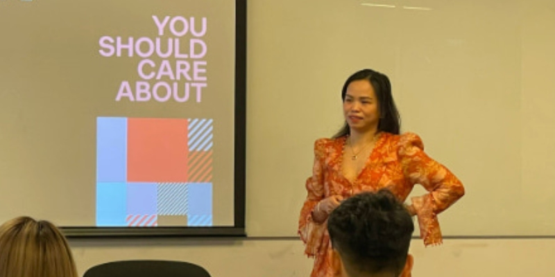 Photo of a lecturer teaching in front of a white board titling influencer trends you should care about to a group of postgraduate students