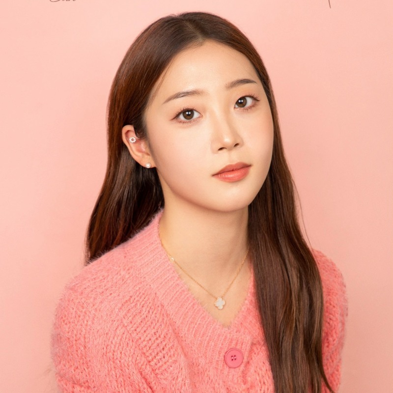 A girl wearing a pink cardigan 