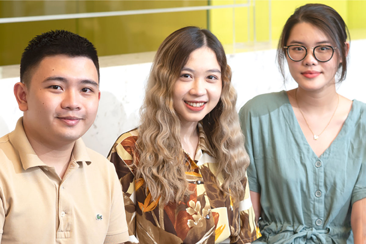 a group of five students smiling