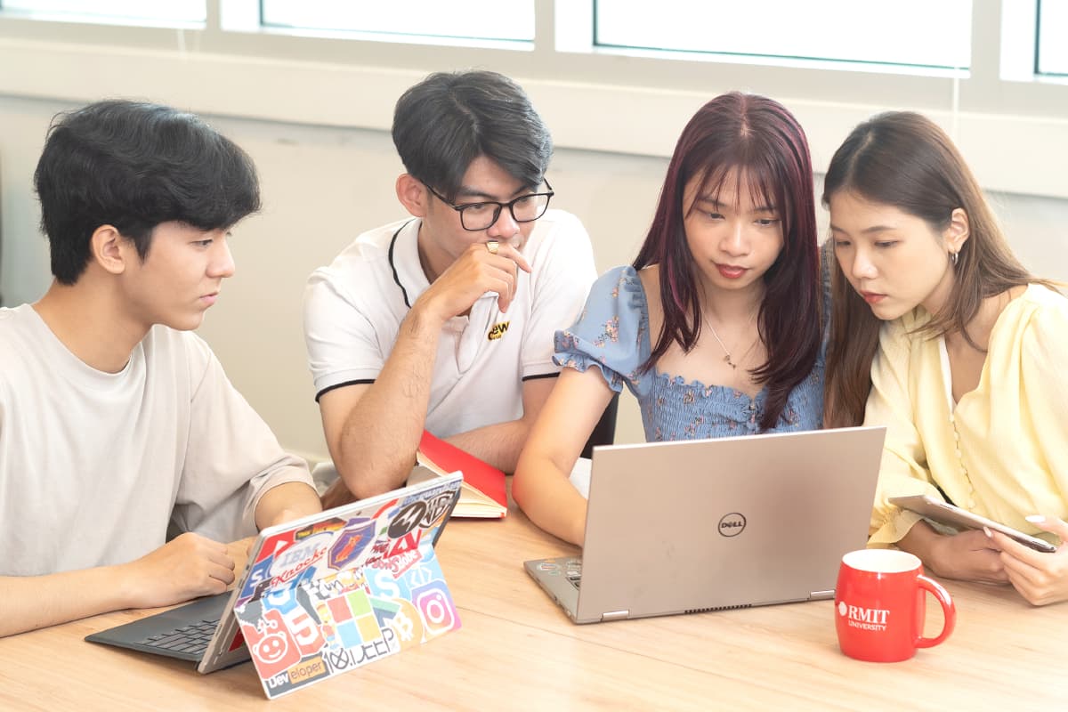 four students discussing work 