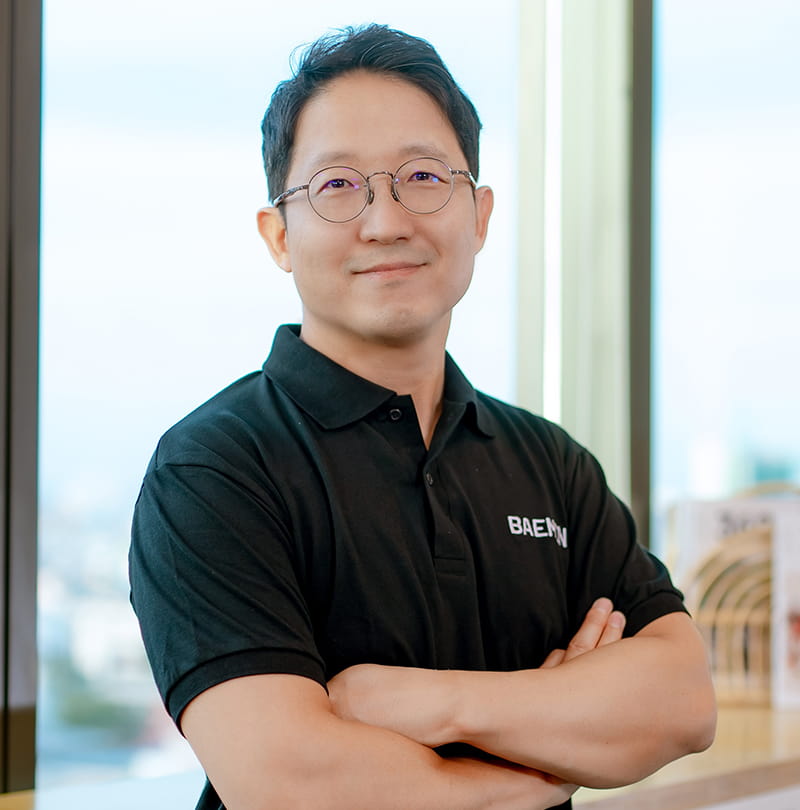 a headshot of an asian man smiling 