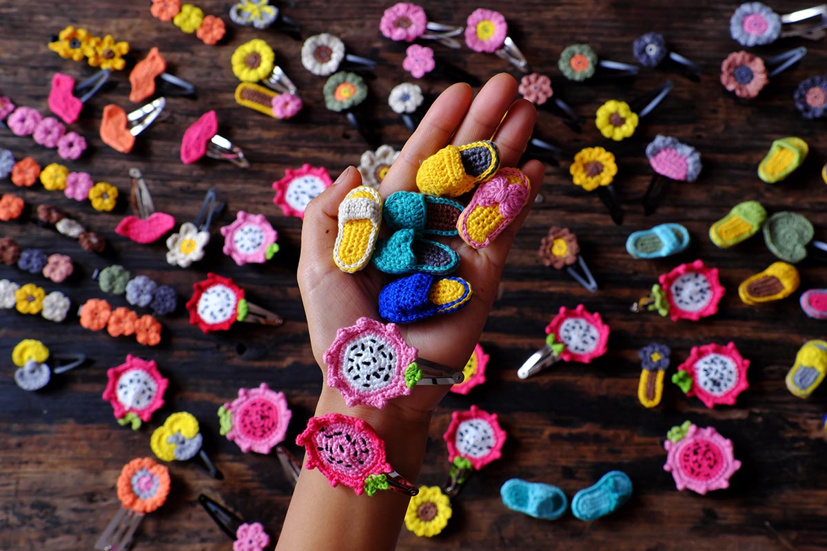 hands holding crochet handmade hairpins