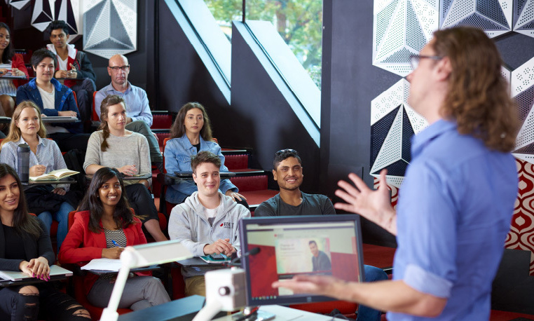 A man lecturing a class of students