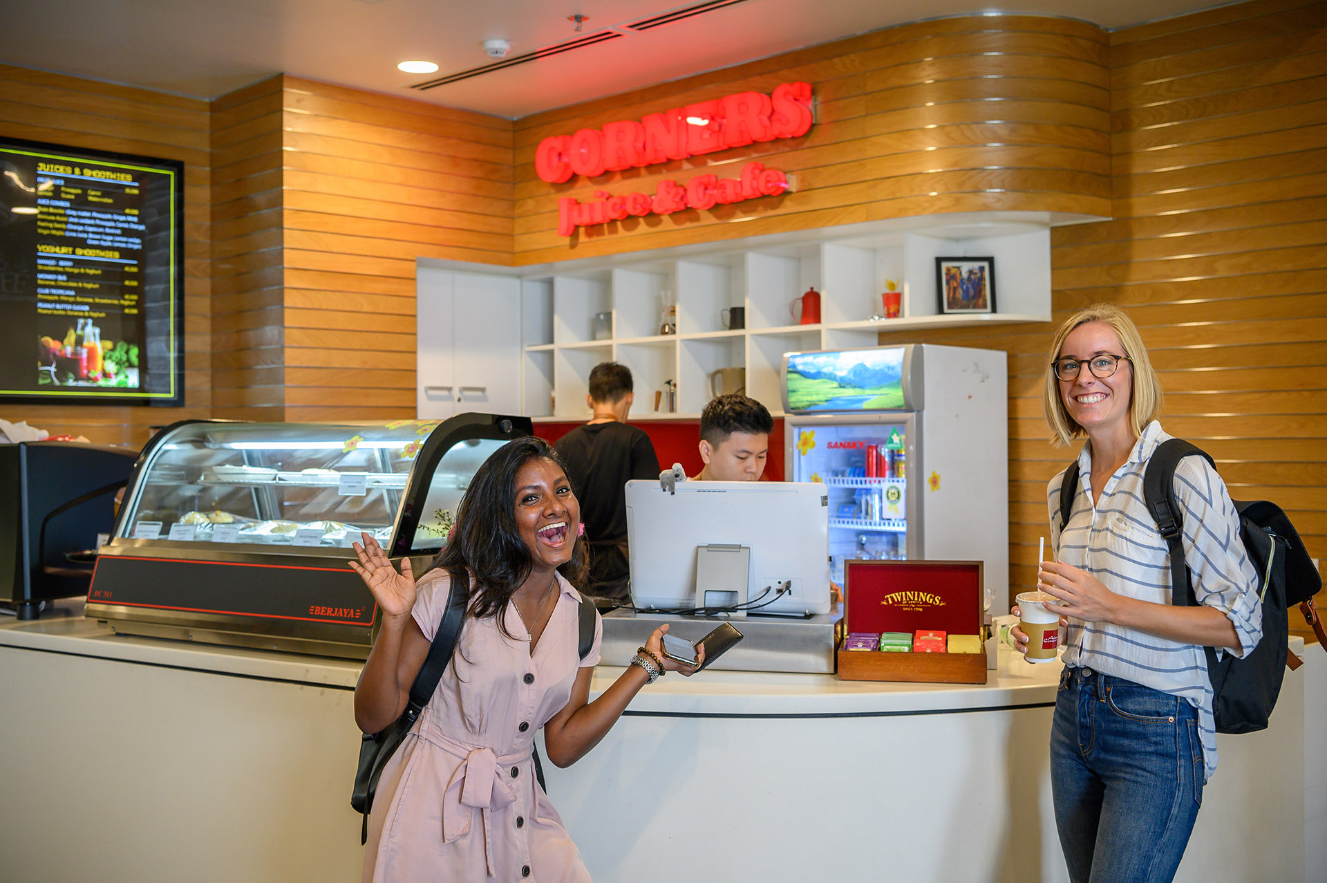 international students laughing at cafe 