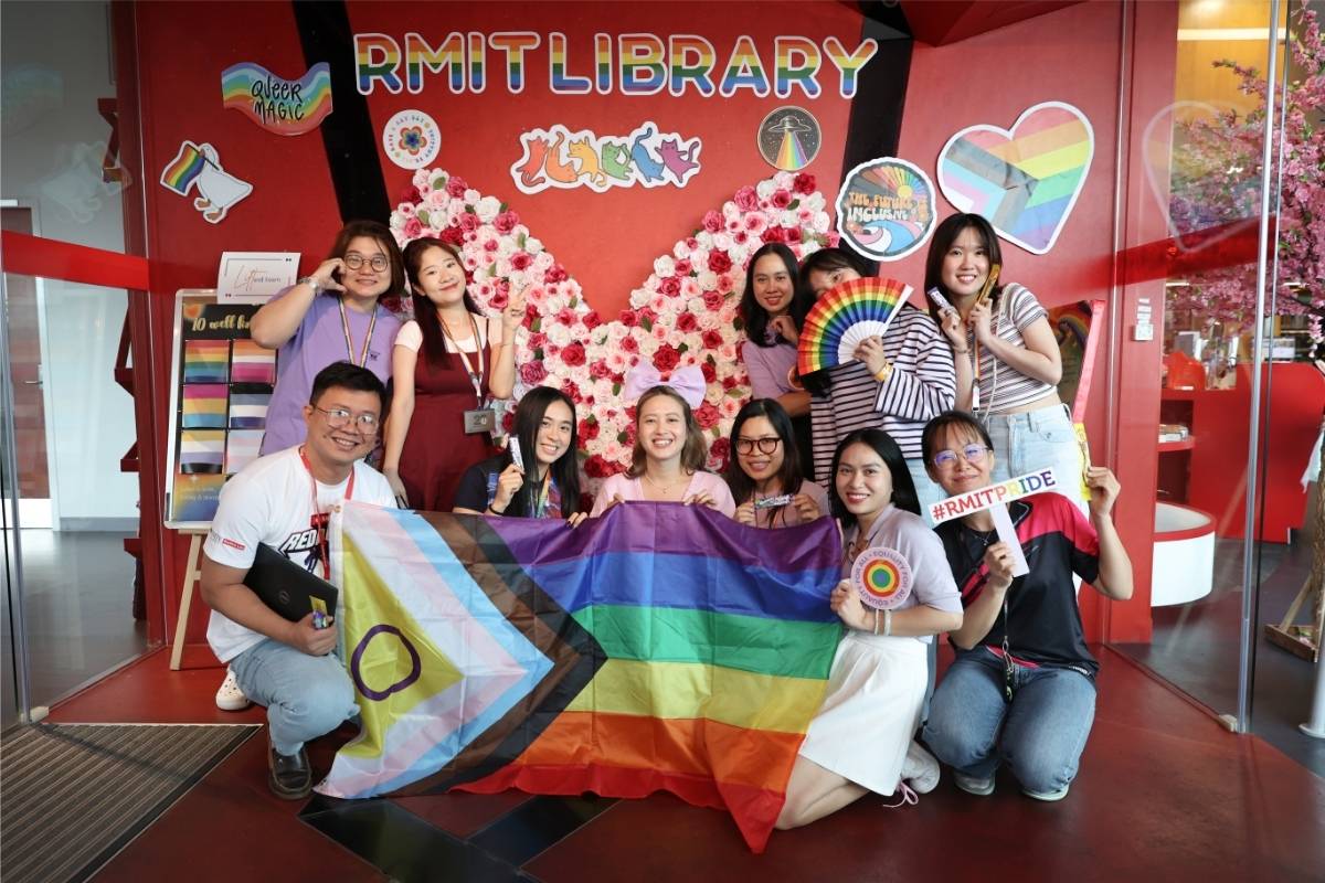 The photo of a group of RMIT staff posing for a group shot inside RMIT Vietnam Library