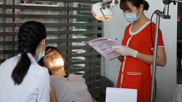 A participant checks services provided by event sponsor HD Dental Center.