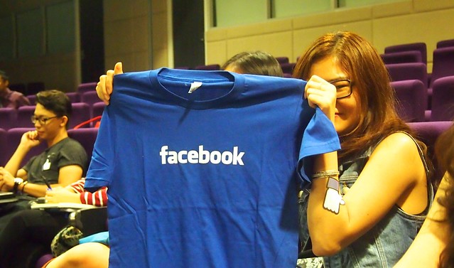 A student receives a gift from Facebook at the Open House event.