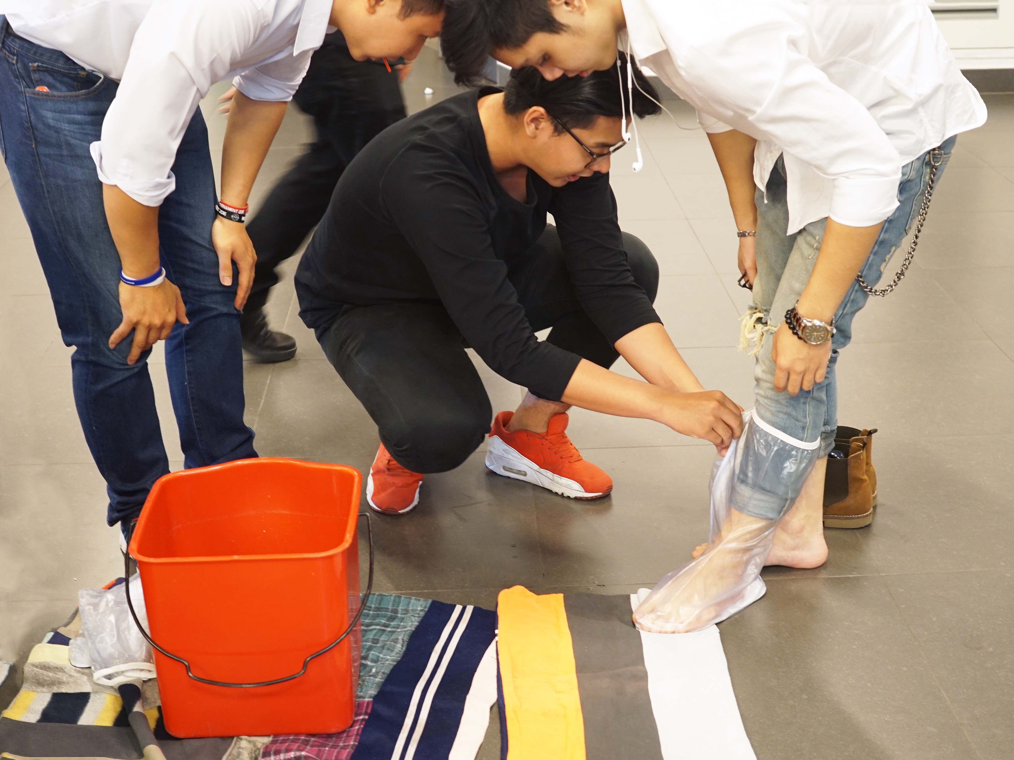 A visitor to the expo tests Conshoes, plastic shoe covers to protect shoes during the rainy season.