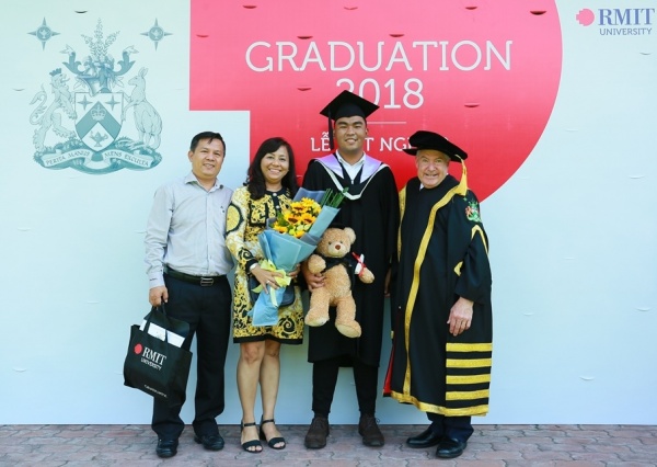 RMIT University Vice-Chancellor and President Martin Bean CBE, with an RMIT graduate and his family at the ceremony in Ho Chi Minh City.