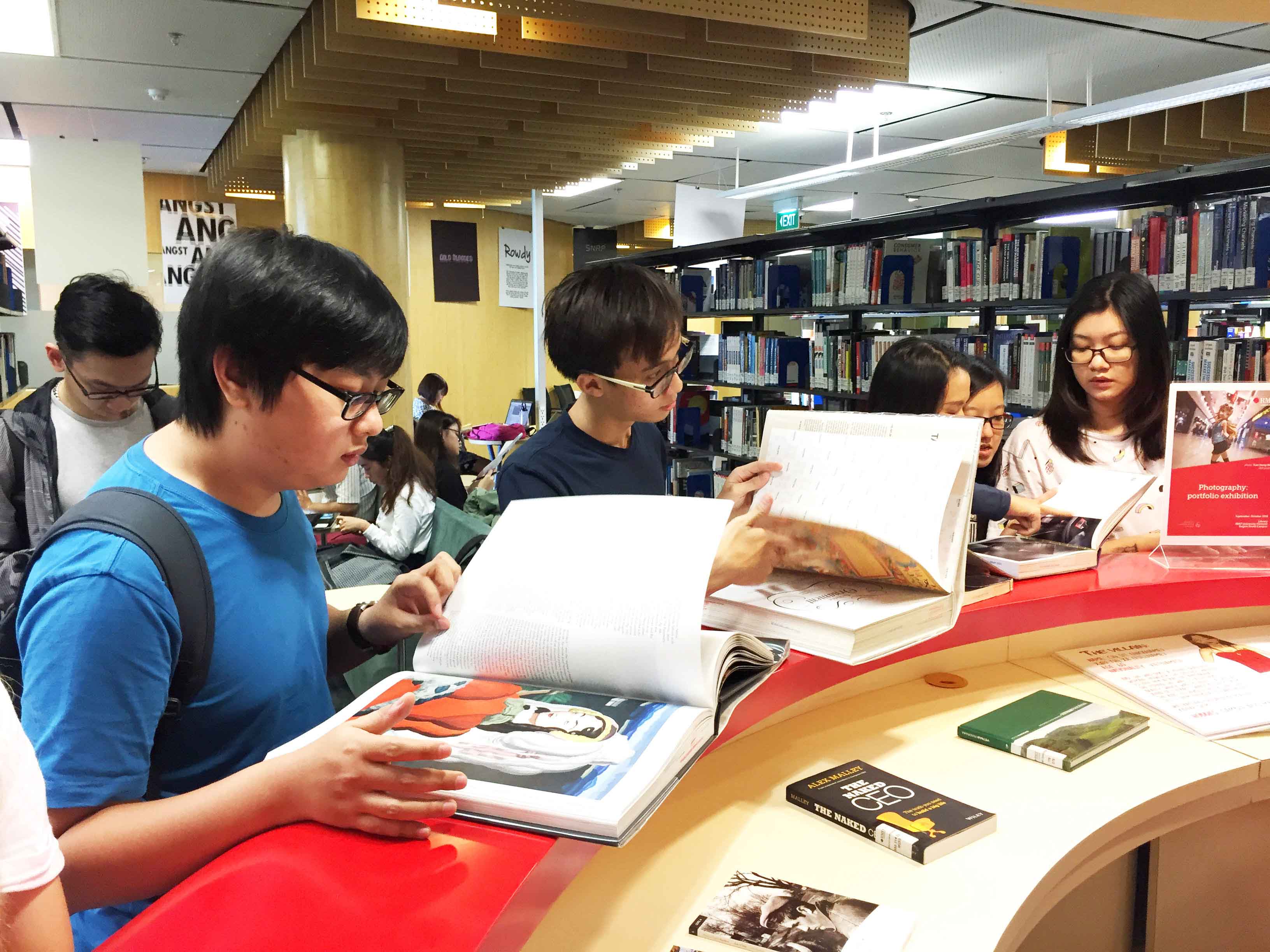 Students look through books at the RMIT Library.