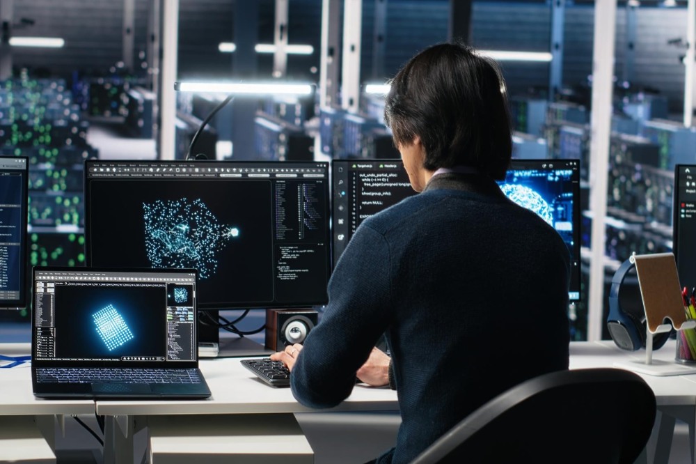 Man programming on computer