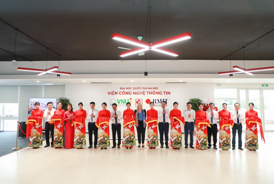 Delegates standing in a row after cutting a red ribbon to mark the opening of the hub