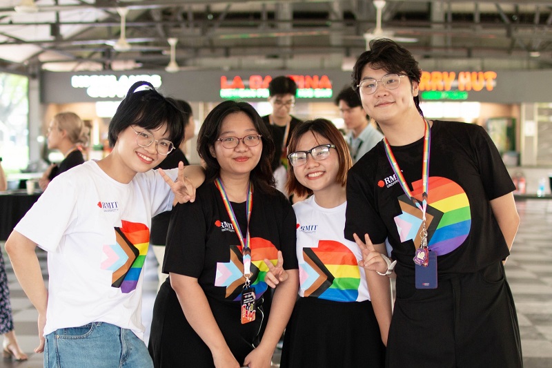 Four RMIT students wearing Pride shirts