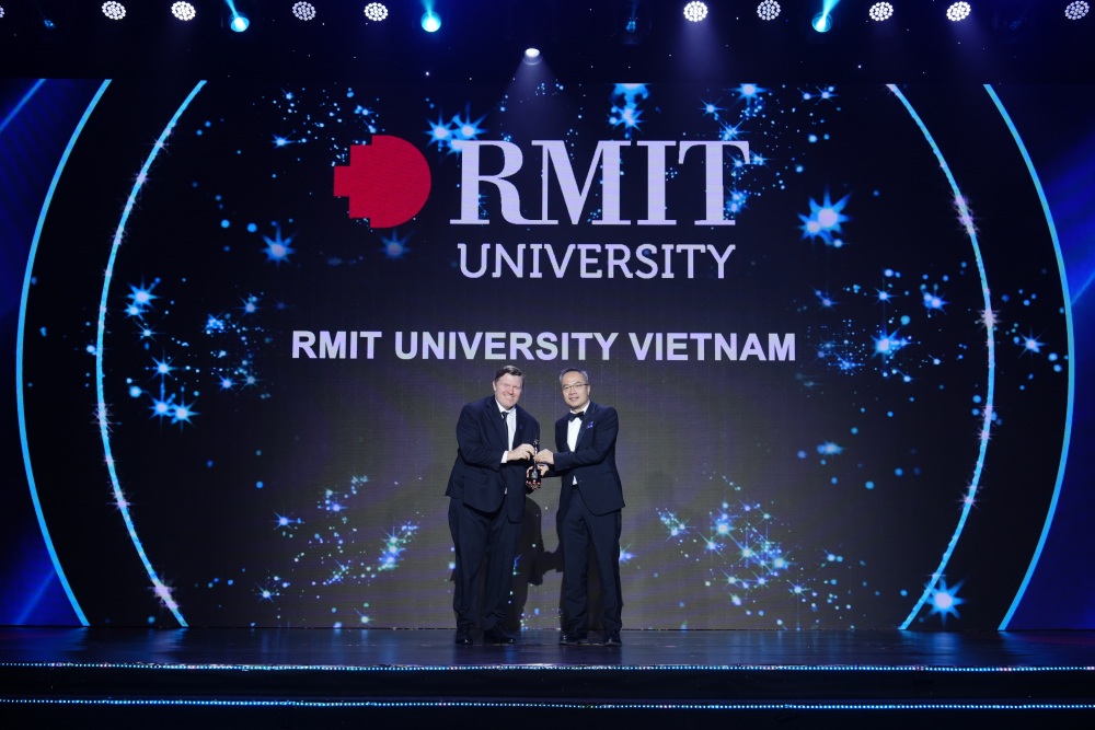 RMIT representative accepts award on stage