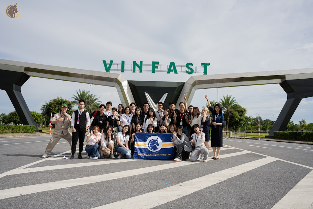 IEC group photo in front of VinFast gate
