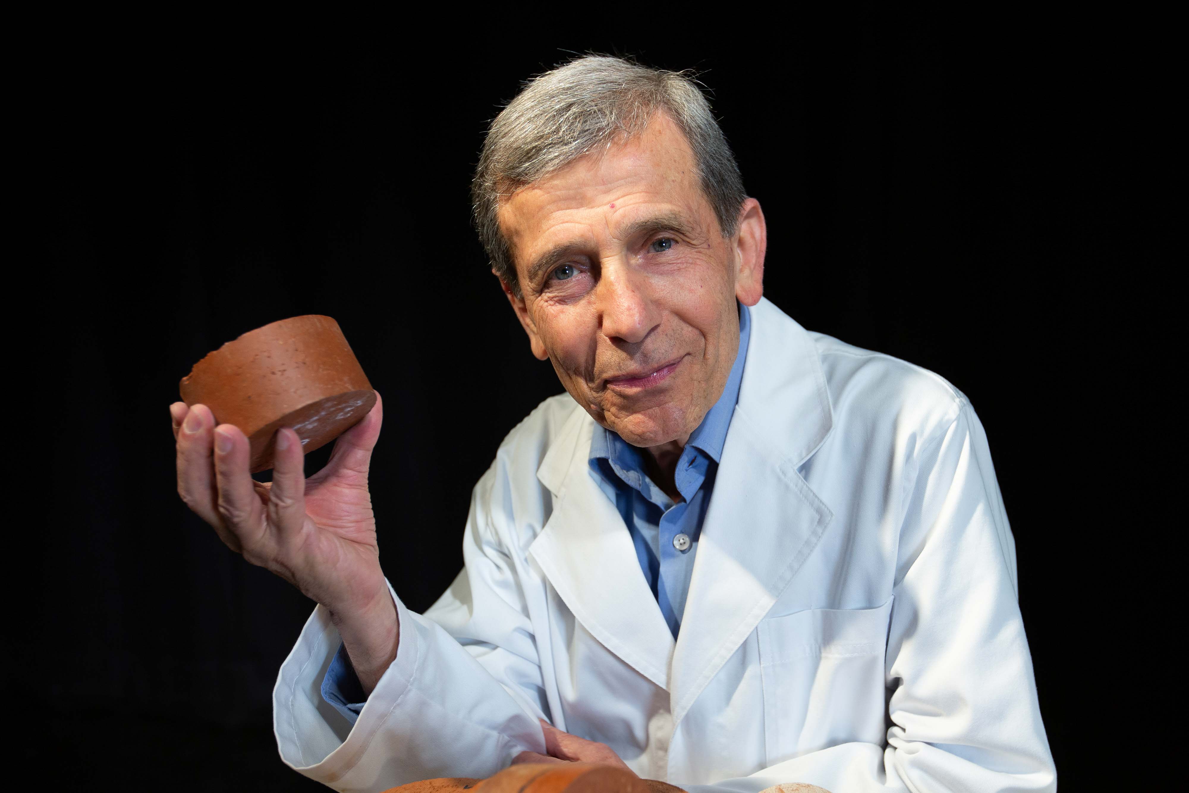 Associate Professor Abbas Mohajerani with a biosolids brick.