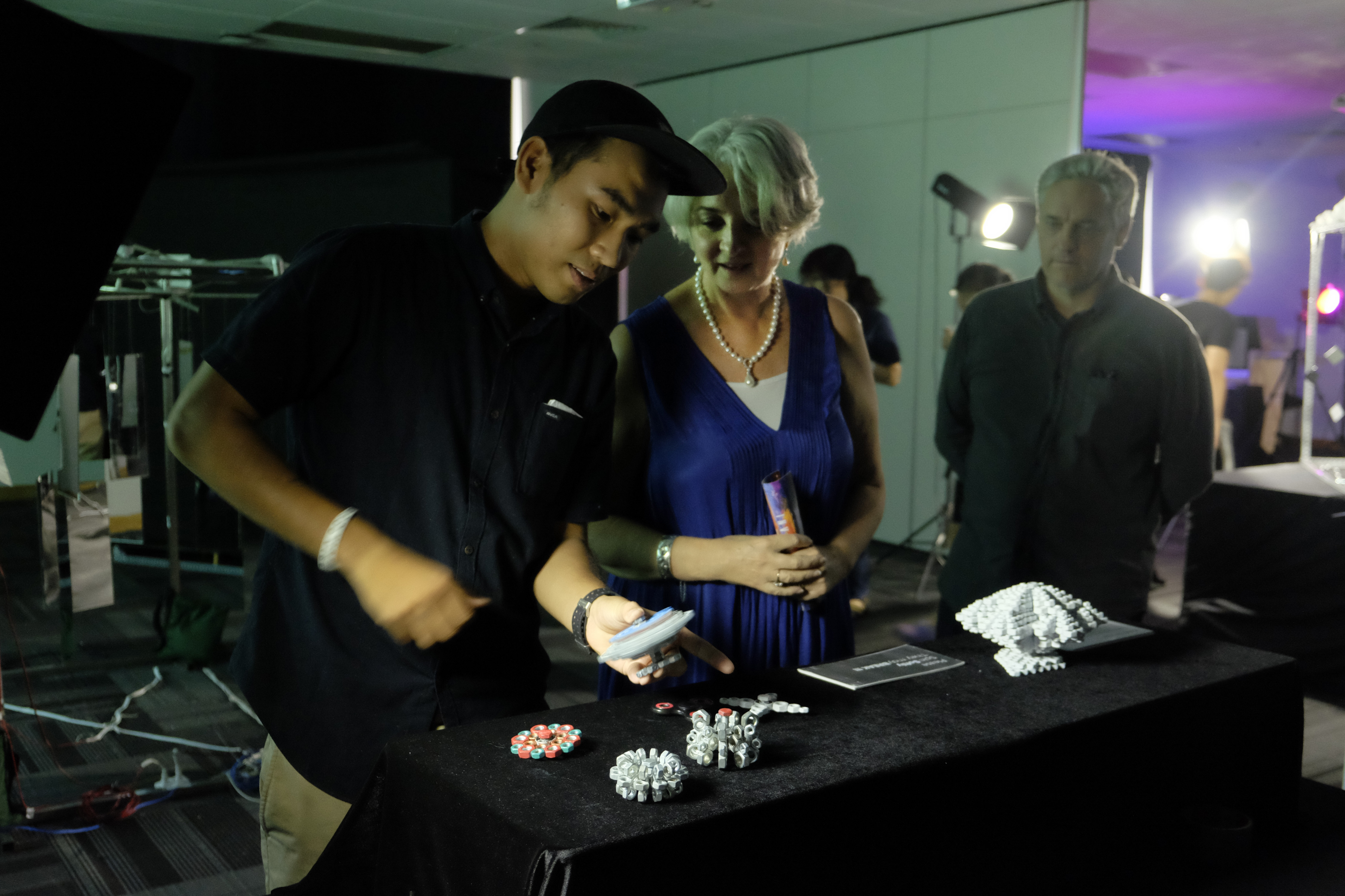 Sophea Phoung (left) demonstrates his project entitled The Illusion of Spinner to RMIT Vietnam President Professor Gael McDonald (middle) and Senior Educator Andy Stiff (right).