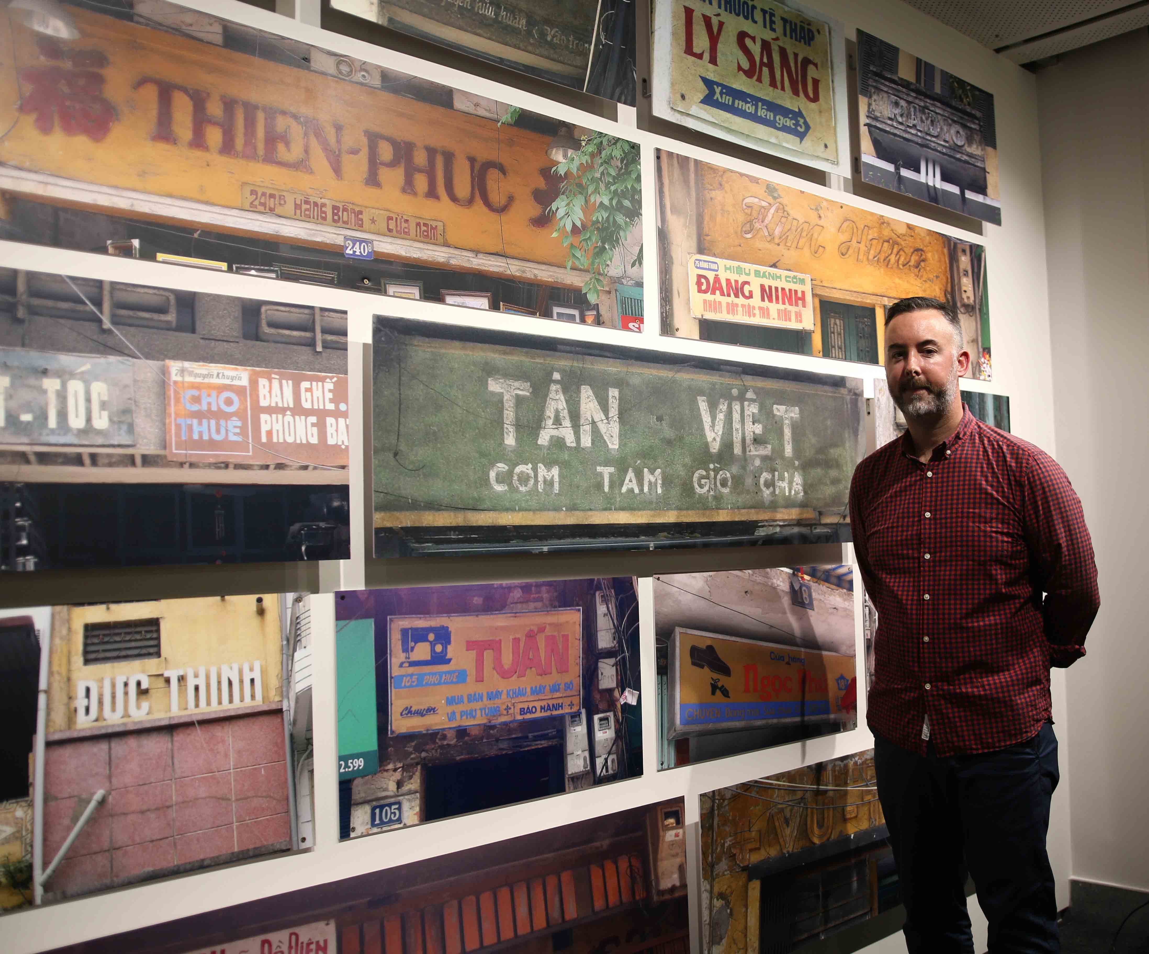 RMIT Vietnam Lecturer Simon Richards with the hand-painted signs he captured with his team in Hanoi’s Hoan Kiem District.