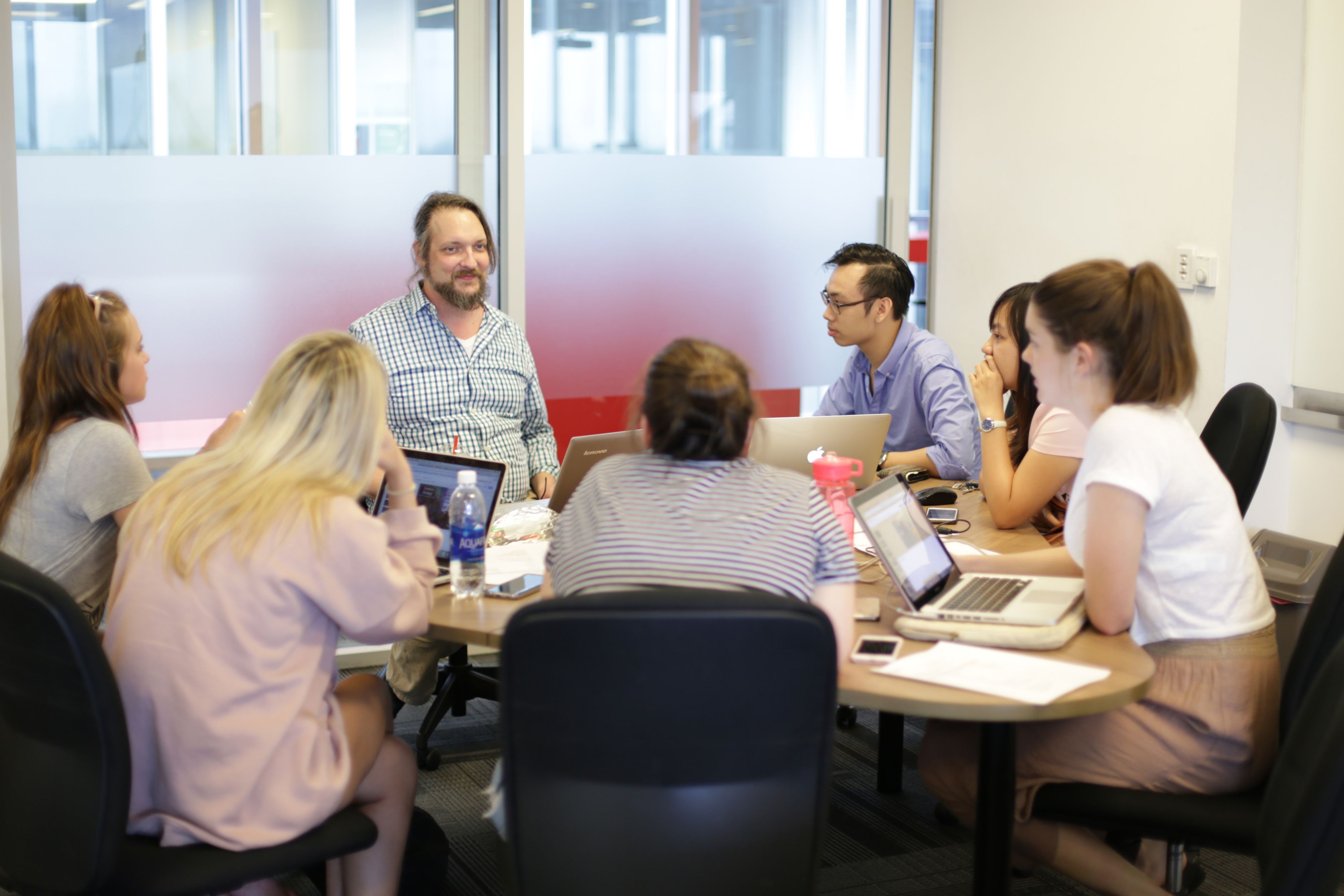 Bryan Urbsaitis facilitates a group discussion with students from the US, Australia, and Vietnam.