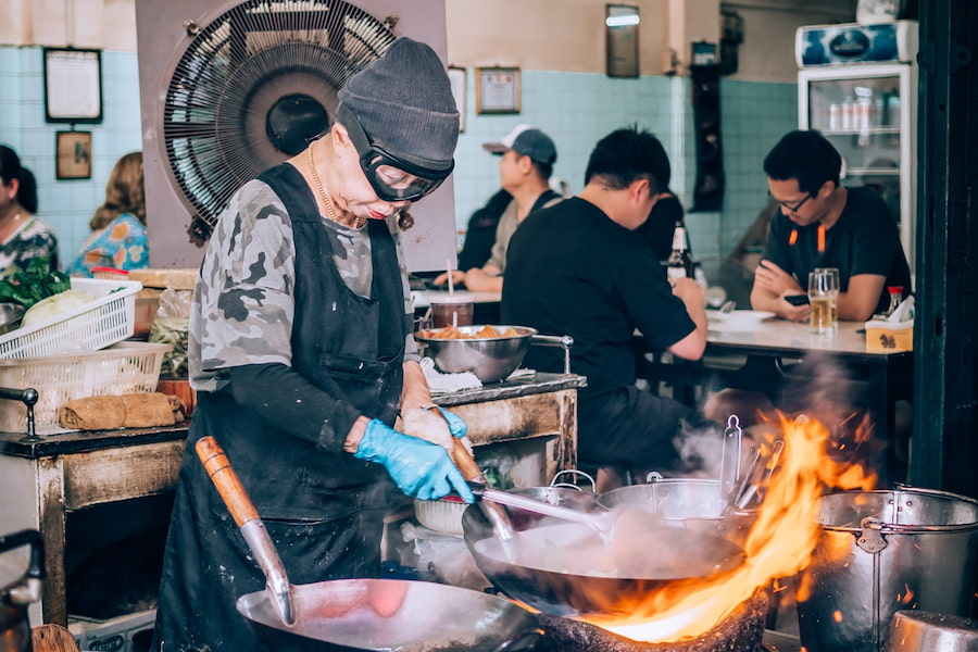 Chef Supinya Junsuta cooking in her Michelin-starred Jay Fai eatery in Bangkok, Thailand.