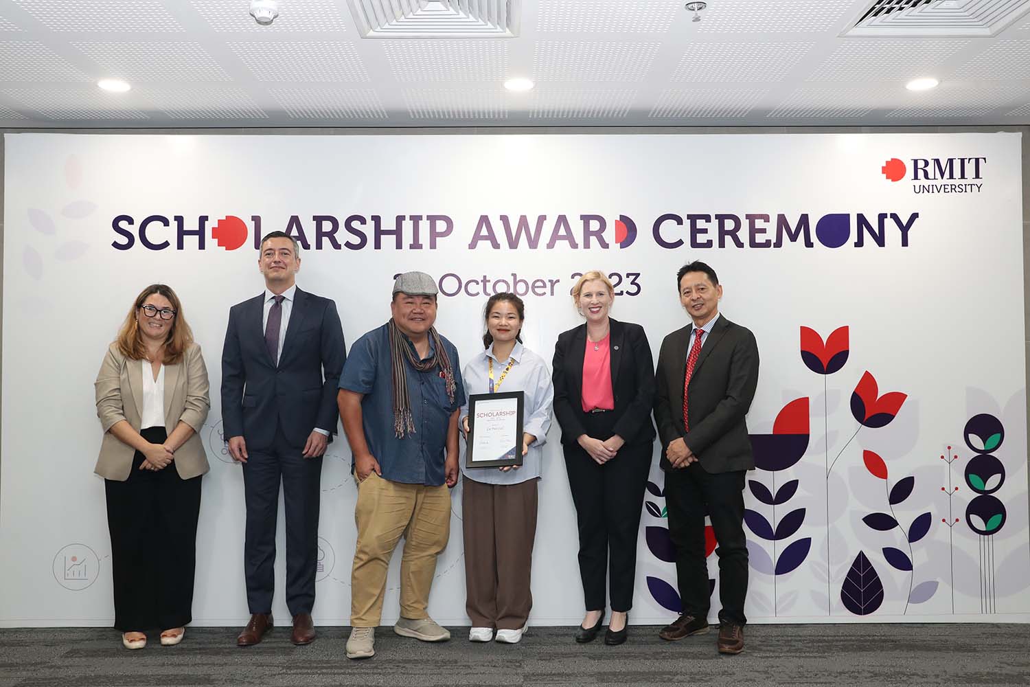 Mai Cuc and Mr Jimmy Pham (wearing hat) at the Scholarship ceremony.