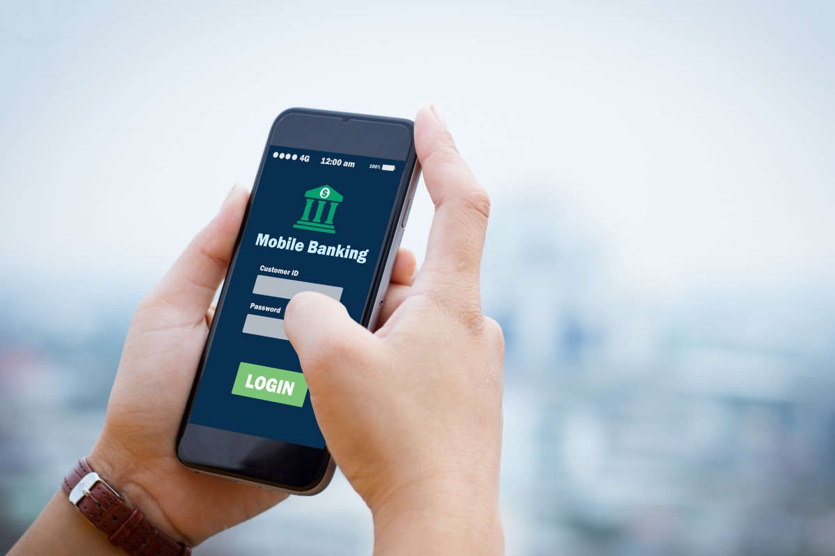 Two hands holding a smartphoen showing a mobile banking app