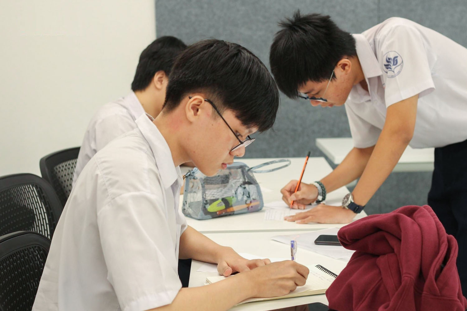 Thinh (pictured in the foreground) with his teammates during a debate tournament.