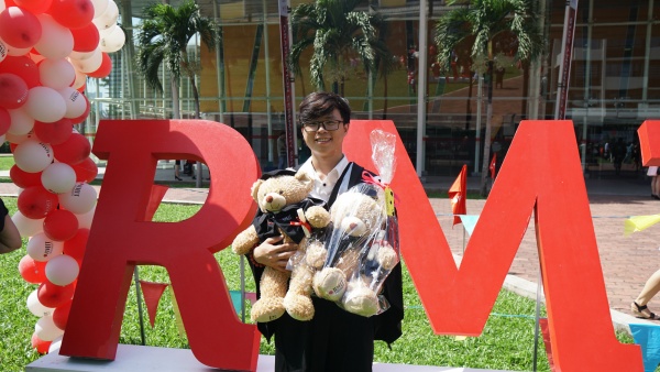 Vo Anh Nhan receives gifts from his family on graduation day at Saigon South campus.