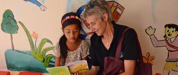 Sister Trish reads a story to a child during her time with Loreto Vietnam, a not-for-profit organisation that aims to bring justice, equality and healing to the world, particularly through the education of women. Photo credit: Loreto Vietnam