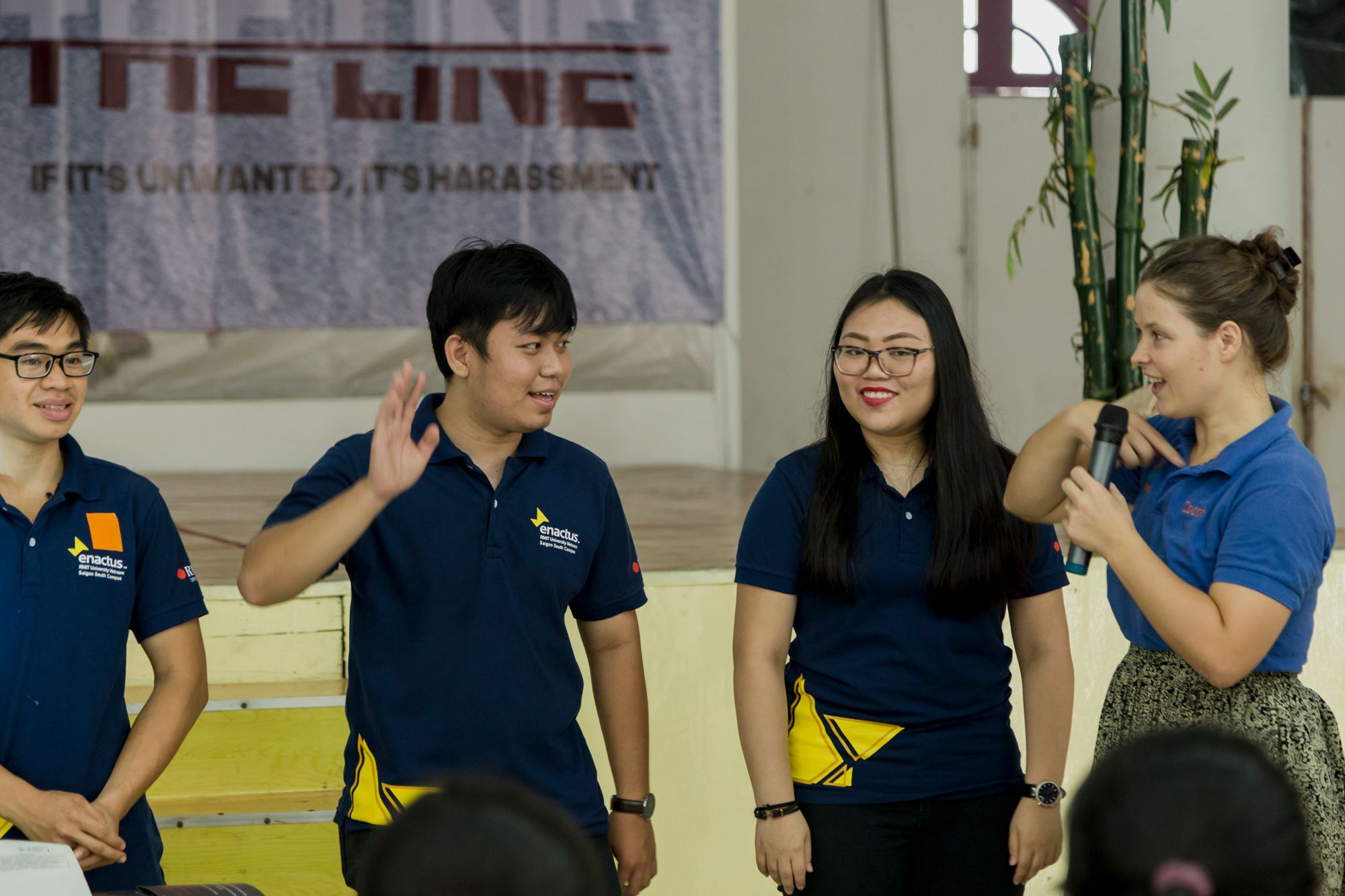 Bachelor of Logistics and Supply Chain Management student and project leader O Thanh Duy Anh (pictured with a hand up) demonstrates a game.  