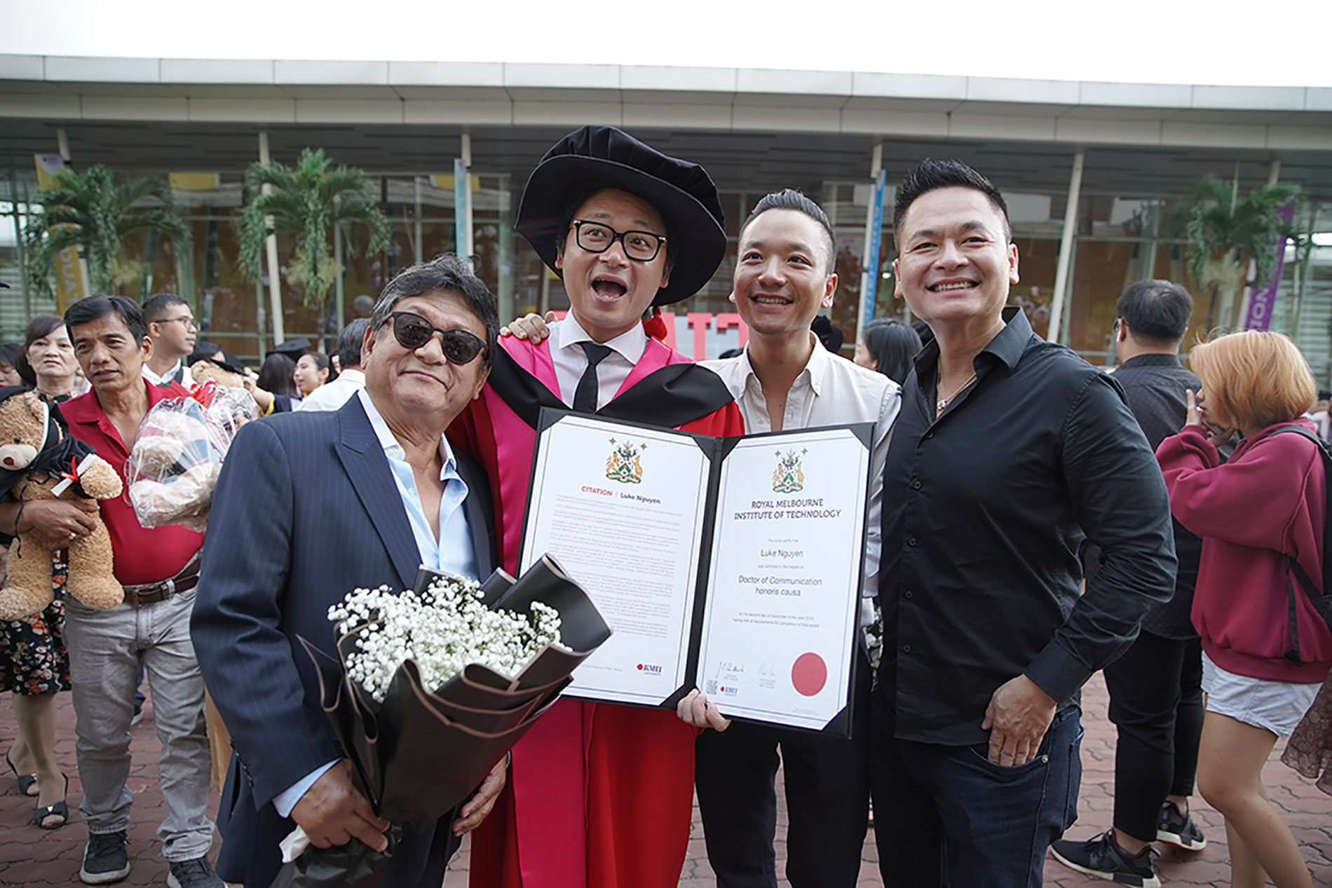 RMIT University’s newly awarded Honorary Doctorate (in gown) and his family at the RMIT Graduation Ceremony at its Saigon South campus on 2 December.