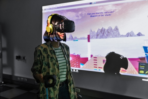 A showcase visitor plays treasure hunt in virtual reality setting