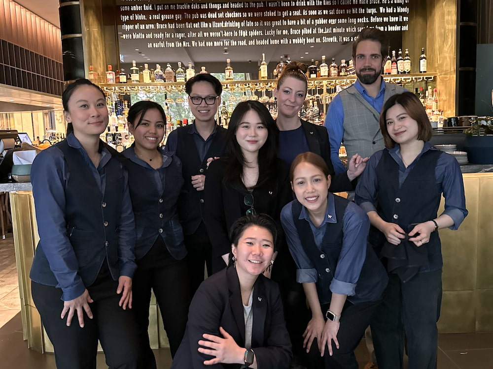 Pham Ngoc Bich Phuong (fourth from left, back row) with colleagues at W Melbourne hotel during her internship in Australia. (Photo courtesy of Phuong)